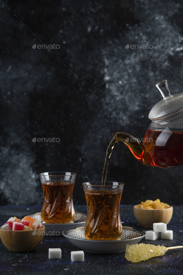 Vertical photo. Pouring tea to the glass