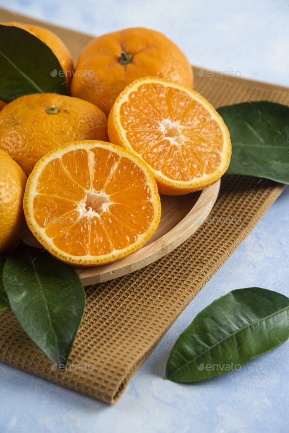 Close up photo of half cut or whole fresh clementine mandarin