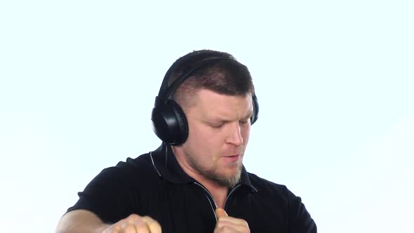 Man Listening To Energy Music with Headphones. White. Slow Motion alt
