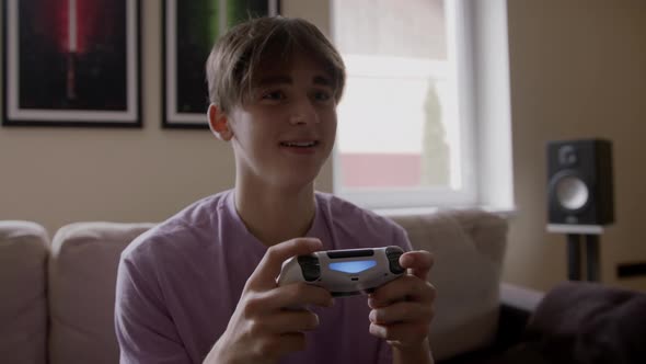 Beautiful Excited Young Gamer Man Sitting on a Couch Playing and Winning in Video Games on a Console alt