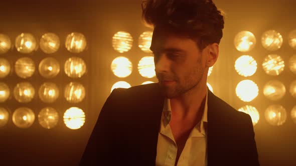Man Model Moving Backwards in Spotlights Close Up alt