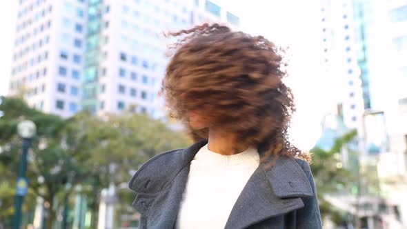 Curly woman laughing and shaking head, slow motion
