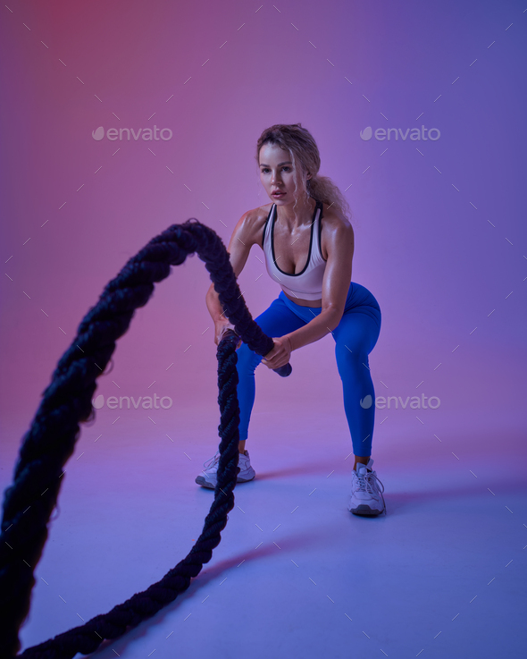 Young sportswoman with ropes in studio, crossfit - Stock Photo - Images