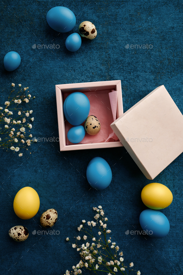 Easter eggs in gift box on blue cloth background - Stock Photo - Images