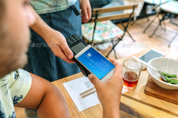 Customer paying the restaurant bill with a virtual mobile card