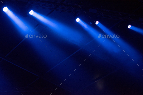 Blue stage lights glowing in the dark. Live music festival concept  background Stock Photo by salajean