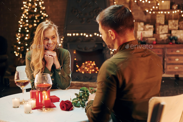 Active conversation. Young lovely couple have romantic dinner indoors together