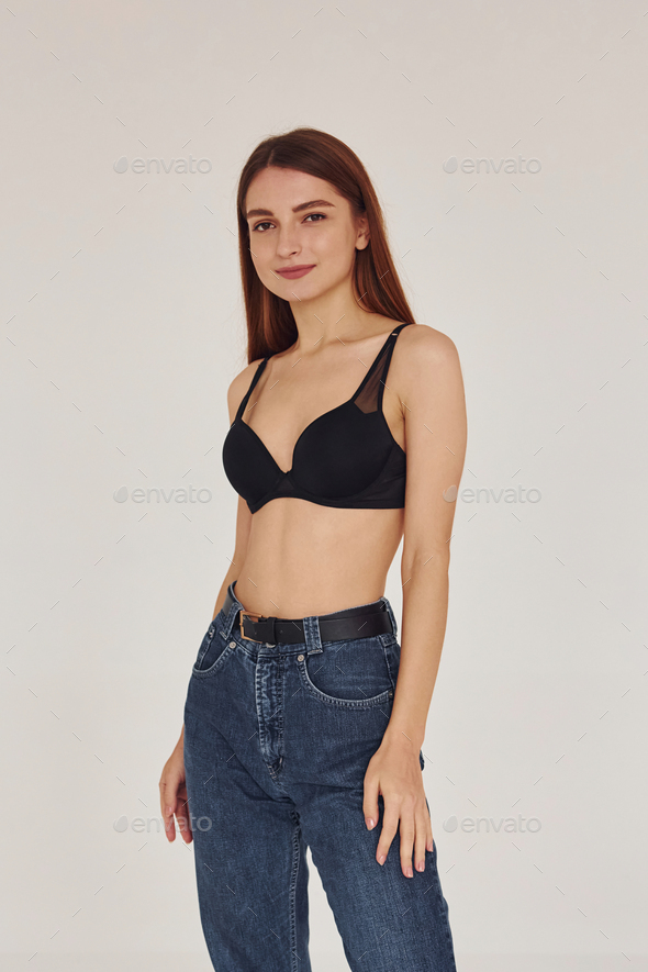 girl In jeans and bra on a White background Stock Photo