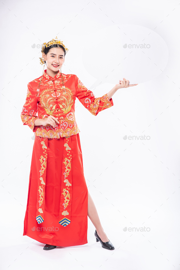 Woman wear Cheongsam suit and black shoe glad getting new things for surprising in chinese new year