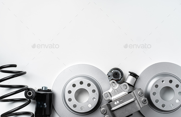 New metal auto parts on grey background