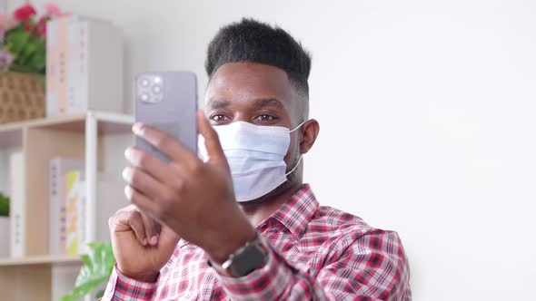 Coronavirus. African man in quarantine for coronavirus wearing protective mask alt