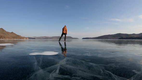 Man Ice Skating on Beautiful Frozen Lake Baikal, Russia