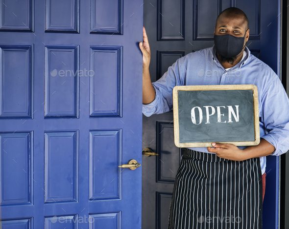 Black business owner in mask during new normal post pandemic