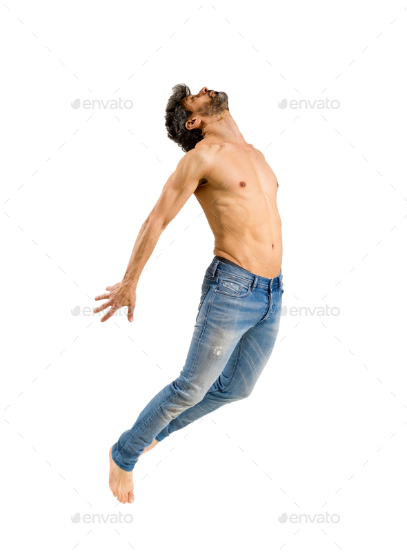 Fit shirtless barefoot man leaping in the air - Stock Photo - Images