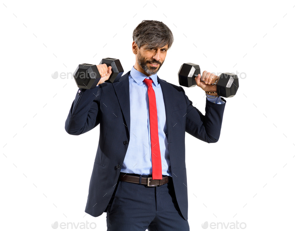 Stylish fit businessman in suit working out with weights - Stock Photo - Images