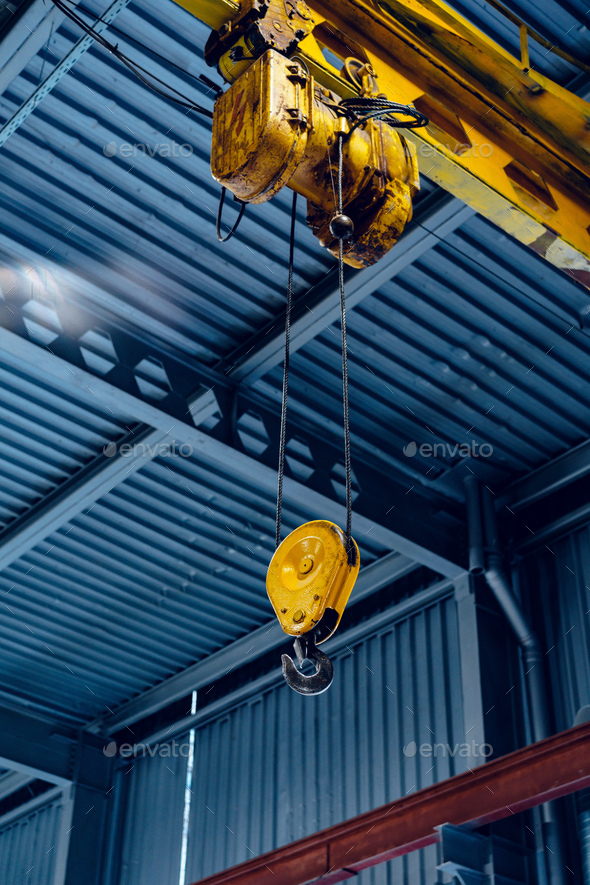 Industrial crane hook in a modern factory building Stock Photo by  FabrikaPhoto