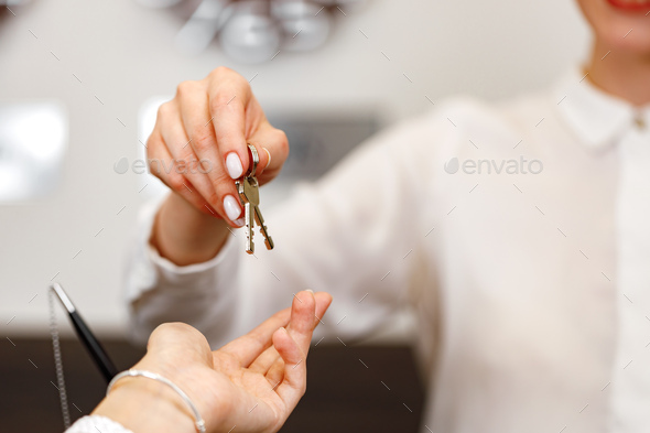 Woman receiving door key in hotel front desk