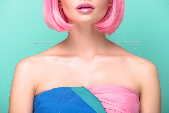 cropped shot of young woman with pink bob cut isolated on turquoise