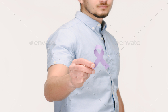 cropped shot of man showing purple awareness ribbon for general cancer awareness, Lupus awareness,
