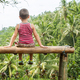 Boy sitting on the bench against the backdrop of the mountains in Ubud, Bali - PhotoDune Item for Sale