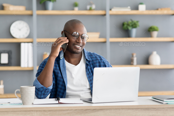 Mobile business communication and entrepreneurship concept. Happy african american businessman - Stock Photo - Images