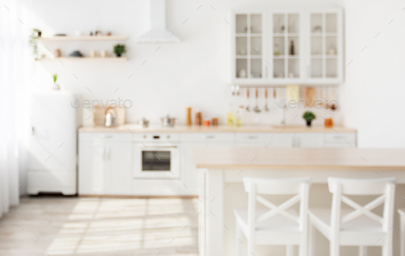 Blurred background with family dining room and minimalist kitchen interior,  kitchenware and utensils Stock Photo by Prostock-studio