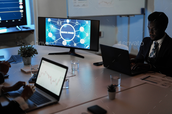 Multiracial traders team making blockchain research inside hedge fund office - Stock Photo - Images
