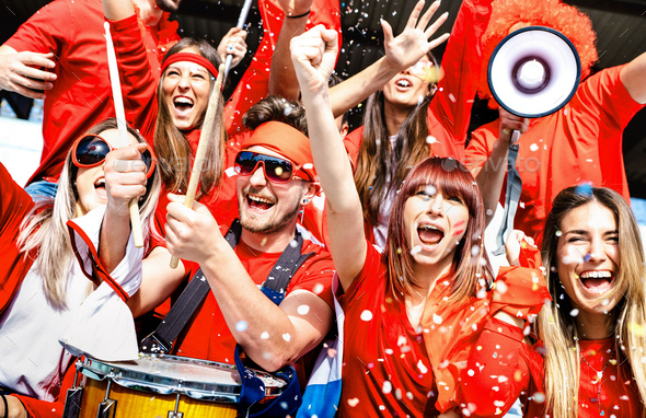 Football supporter fans cheering with confetti watching soccer match cup - Stock Photo - Images