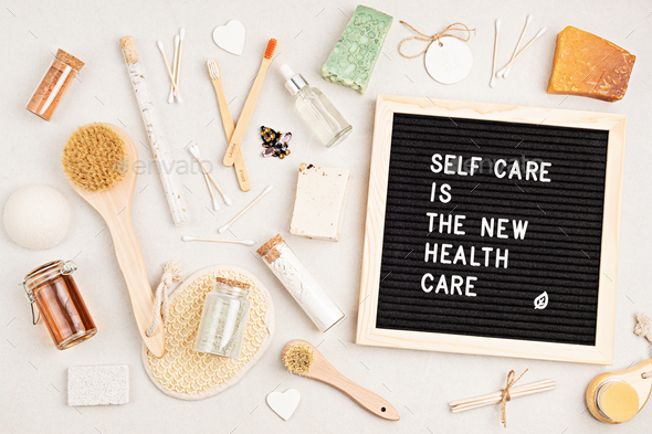 Self care is the new health care. Motivational quote on black letter board with variety of organic