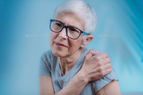 Frozen Shoulder. Senior Woman Holding Cold Compress, Ice Bag Pack on her Painful Shoulder