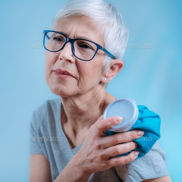 Frozen Shoulder. Senior Woman Holding Cold Compress, Ice Bag Pack on her Painful Shoulder