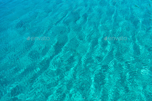 Sea surface turquoise blue color background, some reflections. Stock Photo  by rawf8