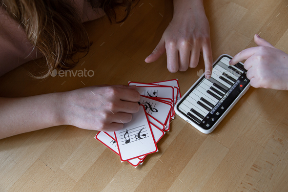 Close-up of cards for studying music and piano in the phone.