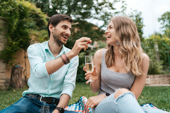Couple drinking sparkling wine with strawberries - Stock Photo - Images