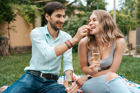 Couple drinking sparkling wine with strawberries - Stock Photo - Images
