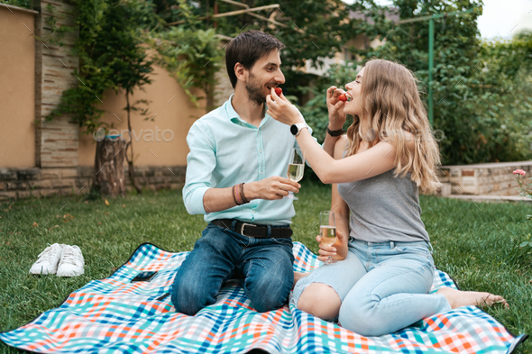 Couple drinking sparkling wine with strawberries - Stock Photo - Images