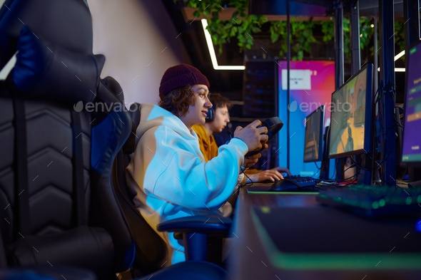 Two young gamers play in game club - Stock Photo - Images