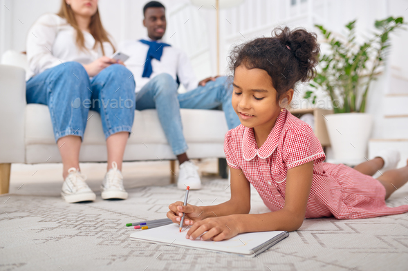Happy family relaxing in living room - Stock Photo - Images