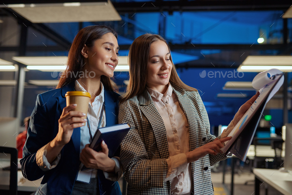 Cheerful women talks in night office - Stock Photo - Images