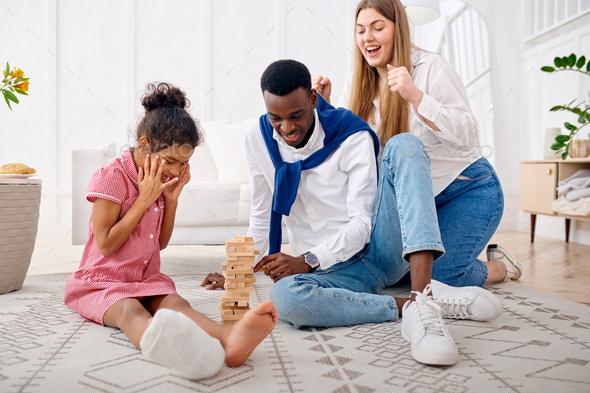 Happy family play game in living room - Stock Photo - Images