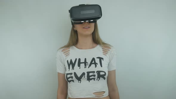 Young Sexy Woman Uses a Virtual Reality Helmet and Full Immersion Technology alt
