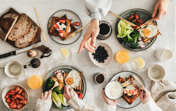 Group of people Friends having breakfast or gathering brunch - Stock Photo - Images