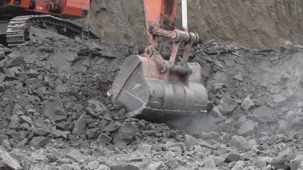 Close-up of an Excavator Bucket Digging Coal