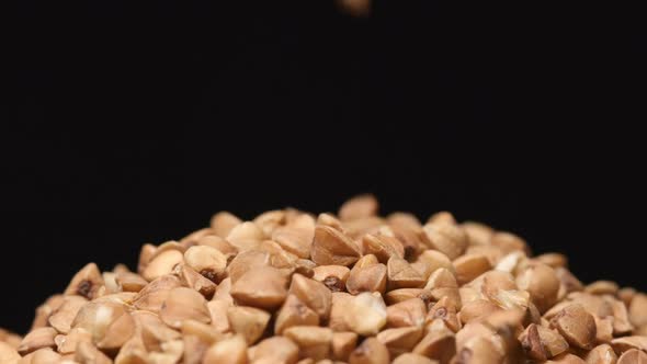 Macro shot of falling of buckwheat on a heap