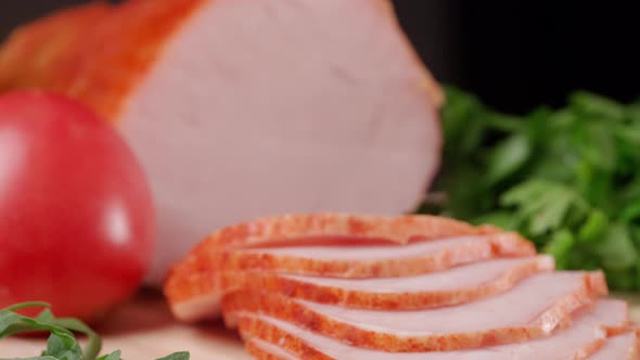 Slicing Traditional Ham Into Pieces on a Wooden Cutting Board with a Knife alt