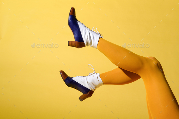 Sexy legs of a woman wearing mustard colored stockings - Stock Photo - Images