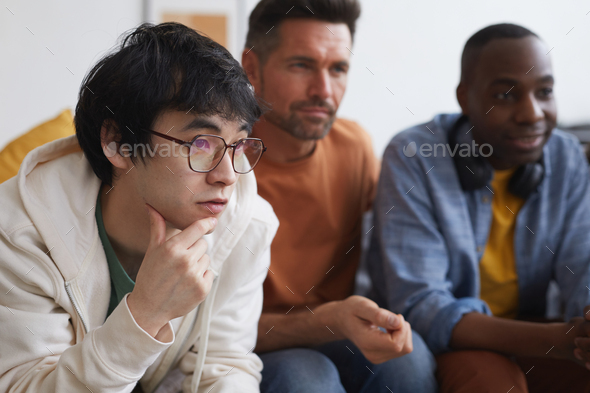 Young Man Watching TV with Friends