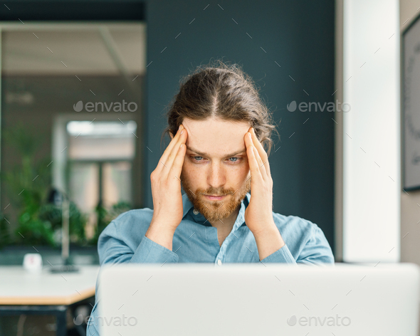 Focused male company employee trying to concentrate - Stock Photo - Images
