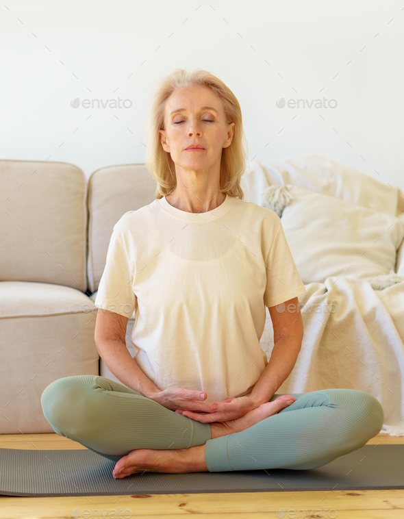 fitness instuctor teaching to do the full lotus pose correctly. side view  full length photo Stock Photo - Alamy