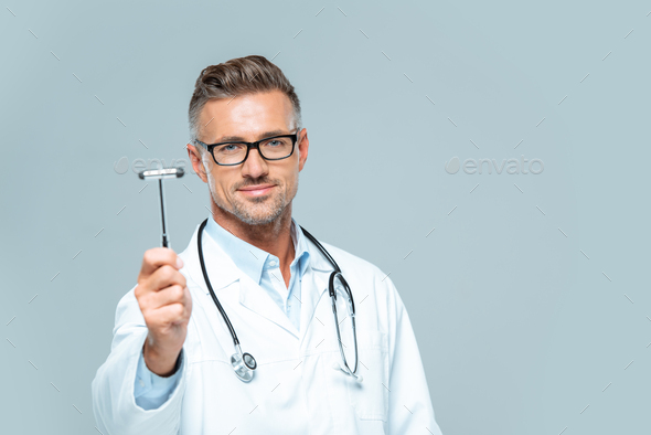 handsome neurologist with stethoscope on shoulders showing reflex hammer isolated on white